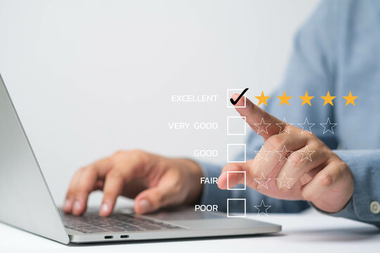 A hand selecting a rating on a laptop, showcasing a feedback process with five-star review system.