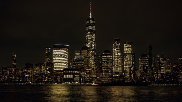 World Trade Center skyline at night. One World Trade Center at night time. WTC memorial. New York City skyscrapers. Freedom Tower. - Powered by Adobe