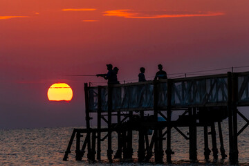Obraz premium sunrise on beach with a trestle at Cervia Italy