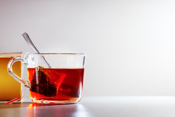 glass cup with teabag on the table, home tea drinking.