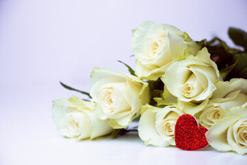 A glittery red heart lies atop elegant white roses, symbolizing love and purity. A perfect representation of romance, passion, and beauty for Valentine's Day