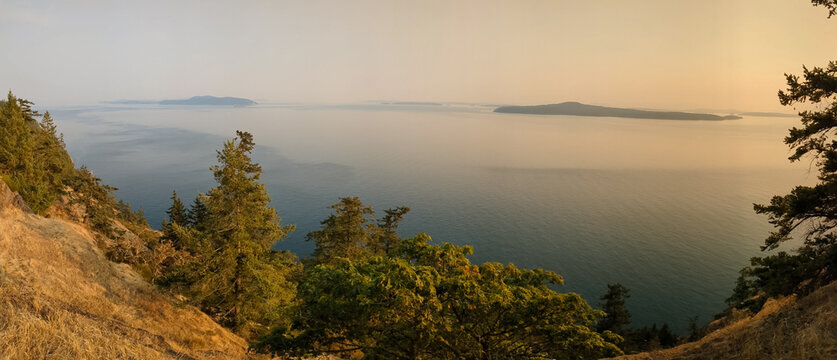 Smoky skies from seasonal wildfires colour the sky over  Pender Island Canada looking over the Salish Sea and southern gulf island