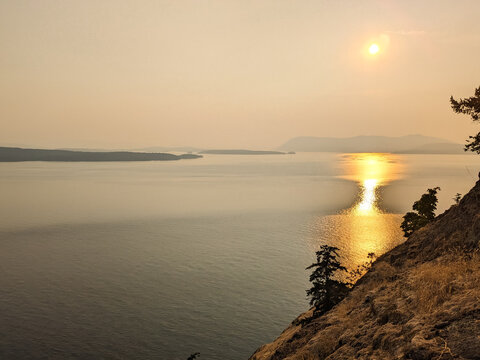 Smoky skies from seasonal wildfires colour the sky over  Pender Island Canada looking over the Salish Sea and southern gulf island