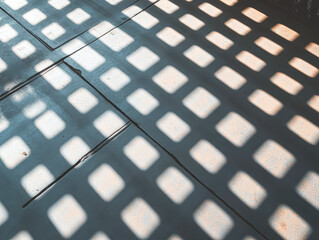 A shadow of a building on a sidewalk