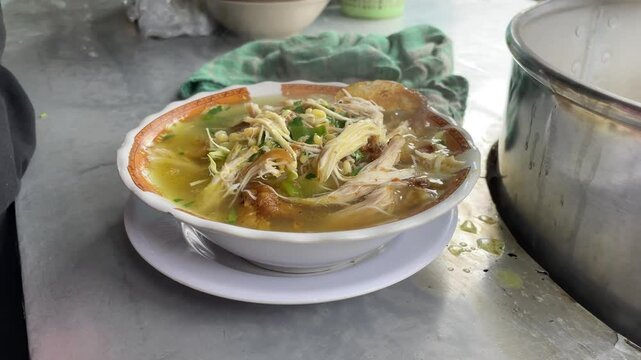 prepare a bowl of indonesian chicken soup or soto ayam.