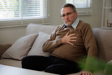Elderly man with chest pain suffering from heart attack, Senior heart disease.