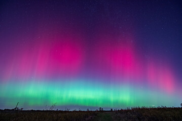 Northern Lights display  in an open grass field