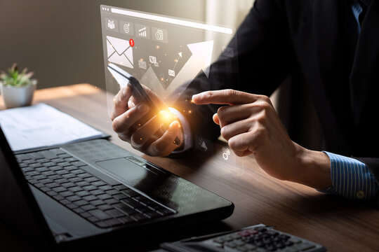 Business Professional Using Smartphone with Digital Marketing Icons, Analyzing Online Campaign Data, and Strategizing Email Marketing for Customer Engagement and Revenue Growth