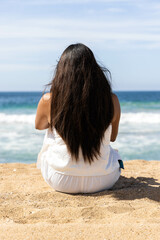 Panorama of beach in Jalisco, Mexico with a person watching the sea in the morning, it seems that the woman is enjoying the tranquility while meditating