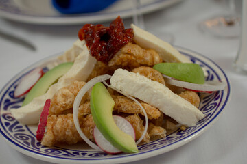 Traditional Mexican chicharrón with creamy cheese, avocado, and smoky chipotle peppers.