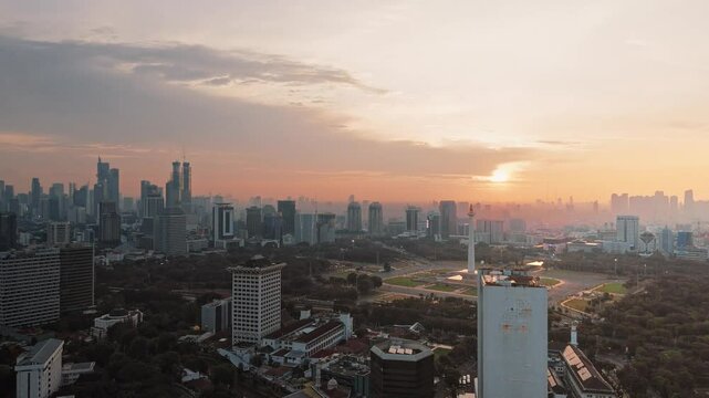 Jakarta, Indonesia - December, 27 2024. Sunset view of Jakarta City from the sky. Monas, the National Monument of Indonesia, in the afternoon. Drone view of Indonesia's National Monument from the sky.