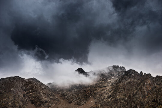 Rocky mountains in clouds - Powered by Adobe