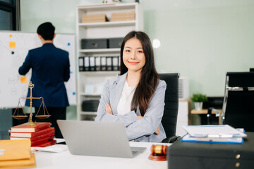 female lawyer celebrating success with documents at a desk, featuring a gavel, scales of justice,