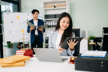female lawyer celebrating success with documents at a desk, featuring a gavel, scales of justice,