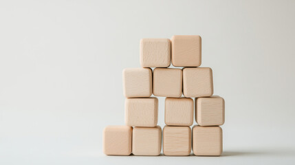 Obraz premium Building blocks arranged in pyramid shape, showcasing simplicity and creativity. Ideal for educational purposes and children playtime