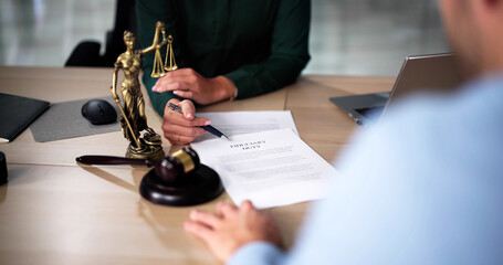 Female Lawyer And Her Client Discussing Divorce Proceedings