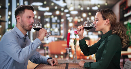 Portrait Of Romantic Couple Toasting Red Wine
