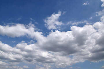 Fototapeta premium white fluffy clouds on clear blue sky, cloudscape background