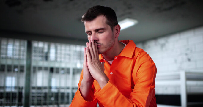 Man Praying To God In Prison Of Jail For Mercy