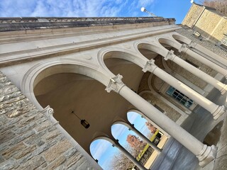 Fototapeta premium Stone archway with ornate columns and lanterns under a clear blue sky
