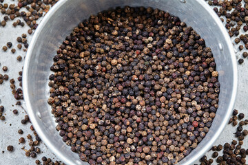 Close-up view of black peppercorns in bowl