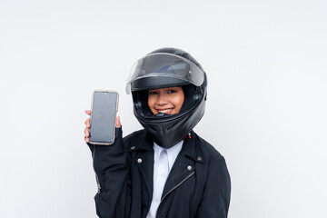 An enthusiastic young rookie Asian woman delivery rider showing a her smartphone screen. Isolated on a white background.