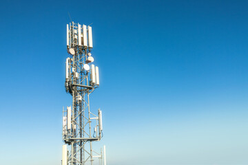 Cellular tower against blue sky landscape
