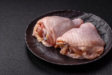 Fresh raw chicken thighs with salt and spices