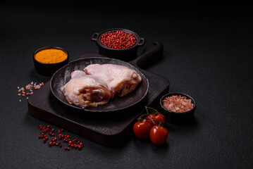 Fresh raw chicken thighs with salt and spices