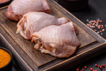 Fresh raw chicken thighs with salt and spices