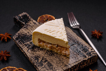 Piece of cheesecake with nuts and berries with winter pattern