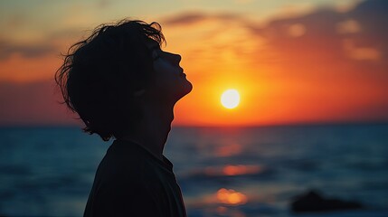 Silhouette of a Person at Sunset by the Ocean