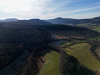 Aerial view of Burgundy, France, with fields, forests and hills in winter