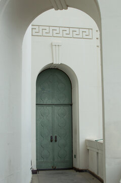 Green archway door in Art Deco style building