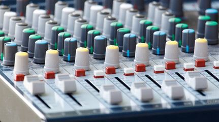 A mixing board with many knobs and buttons