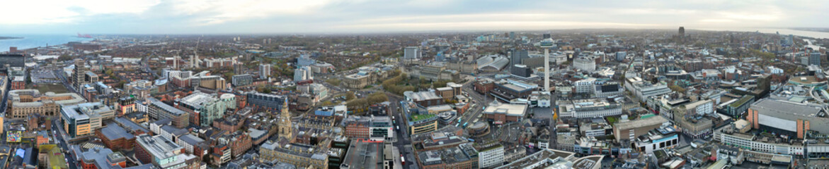 Obraz premium High Angle Ultra Wide High Resolution Panoramic View of Historical Liverpool City of England During Orange Sunrise Moring Time. Drone's Camera Footage on November 11th, 2024 from Medium High Altitude
