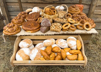 A table full of different types of bread and pastries