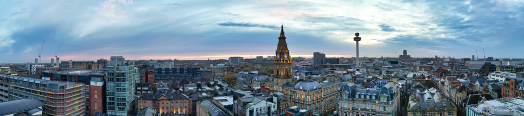 Naklejka premium High Angle Ultra Wide High Resolution Panoramic View of Historical Liverpool City of England During Orange Sunrise Moring Time. Drone's Camera Footage on November 11th, 2024 from Medium High Altitude
