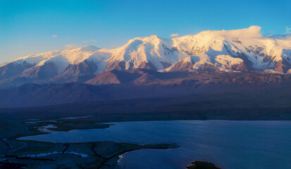 The beautiful scenery of Baisha Lake and Mustag Snow Mountain in the Pamir Plateau of Xinjiang,...