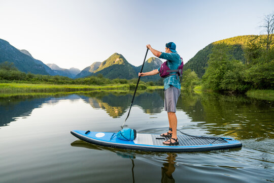 Side view of man paddling on SUP