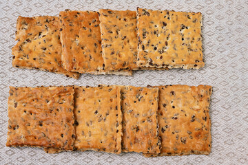Crispy sugar-free cookies with flax seeds lie on a linen napkin