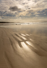 Beautiful morning light over a pristine deserted beach at low tide. Esperance Western Australia.