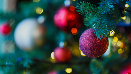 Christmas balls on a Christmas tree. Background with Christmas decorations and lights.