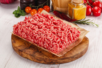 Raw minced beef meat over board