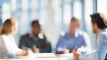 A soft blur of a business team engaged in a goal-setting session during a meeting.
