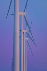 Several TransAlta wind turbines stand tall against a pastel purple sky. Clean energy production in action. , Fort Macleod, Alberta, USA