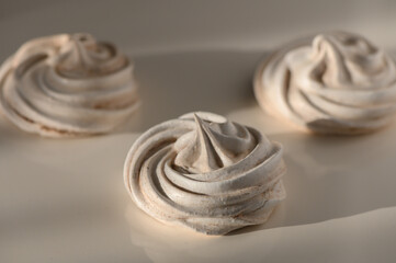 Sweet spirals of meringue resting on a soft surface waiting for a delightful taste experience