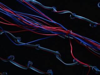 Bright colored LED wires contrast sharply against the dark background.  Tangled colorful wires...