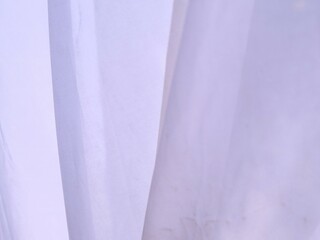 White fabric folds offer attractive linear accents for geometric backdrops. Folded white fabric...
