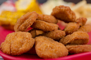 Close-up of crispy golden fish nuggets, highlighting crunchy texture and golden-brown color, perfect for gourmet seafood presentation.